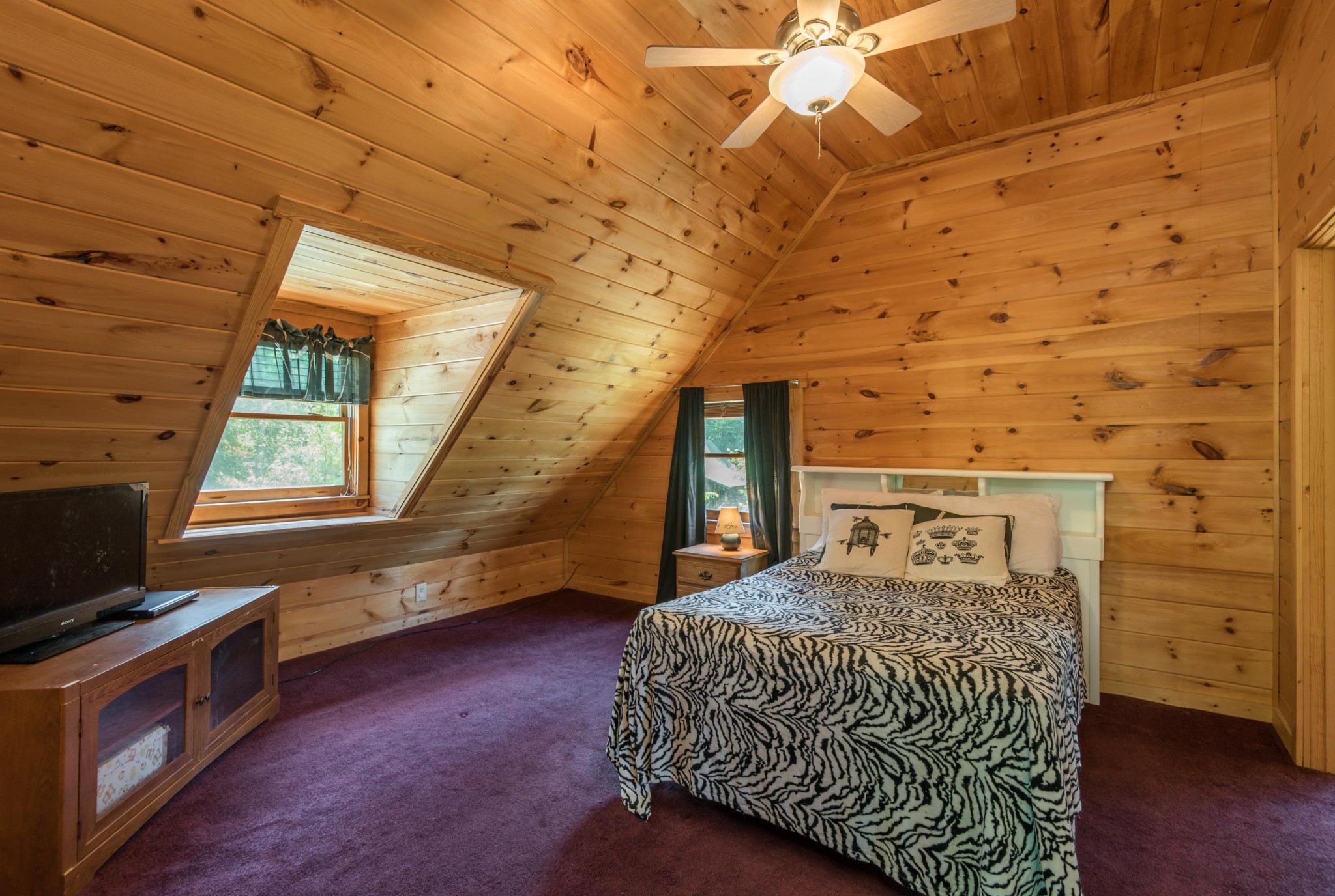 3104 Clearview Road Sevierville, TN 37862 - Photo 26 of 36 a bedroom with a bed and a tv