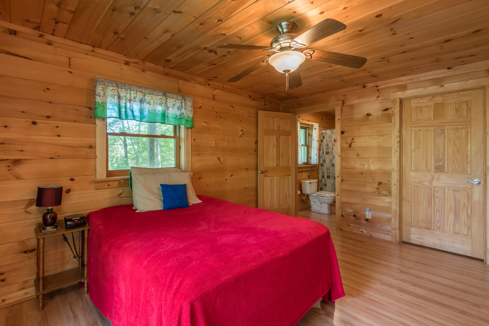 3104 Clearview Road Sevierville, TN 37862 - Photo 32 of 36 a spacious bedroom with a bed and a chandelier