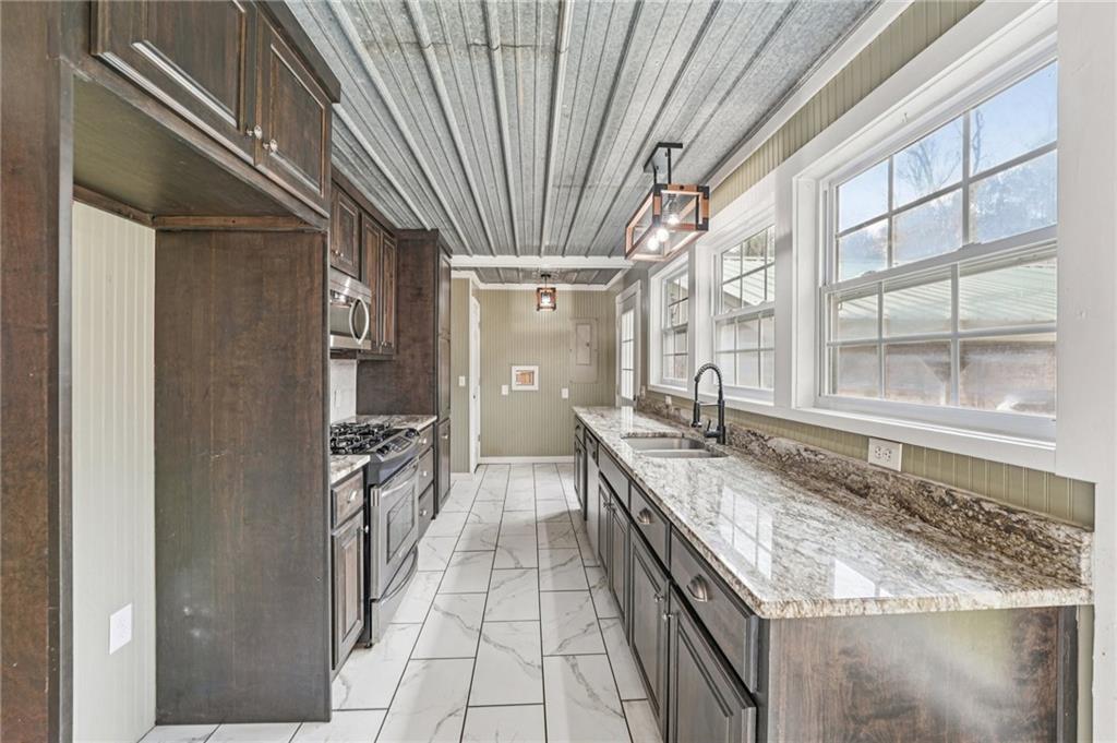 257 Shellhorse Road Southeast Ranger, GA 30734 - Photo 12 of 44 a kitchen with granite countertop a sink and a refrigerator