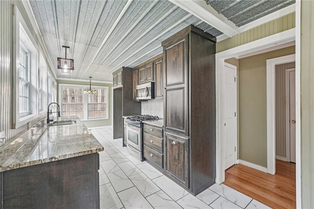 257 Shellhorse Road Southeast Ranger, GA 30734 - Photo 14 of 44 a kitchen with granite countertop a refrigerator and a sink