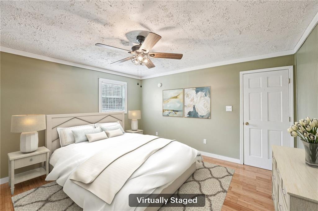 257 Shellhorse Road Southeast Ranger, GA 30734 - Photo 15 of 44 a bedroom with a large bed and a chandelier