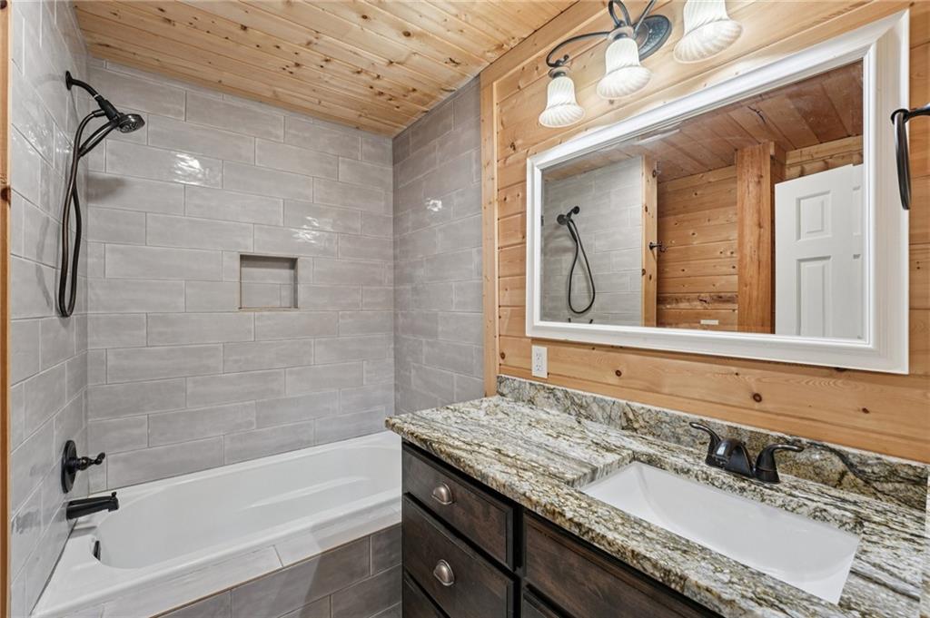 257 Shellhorse Road Southeast Ranger, GA 30734 - Photo 23 of 44 a bathroom with a granite countertop tub sink and mirror