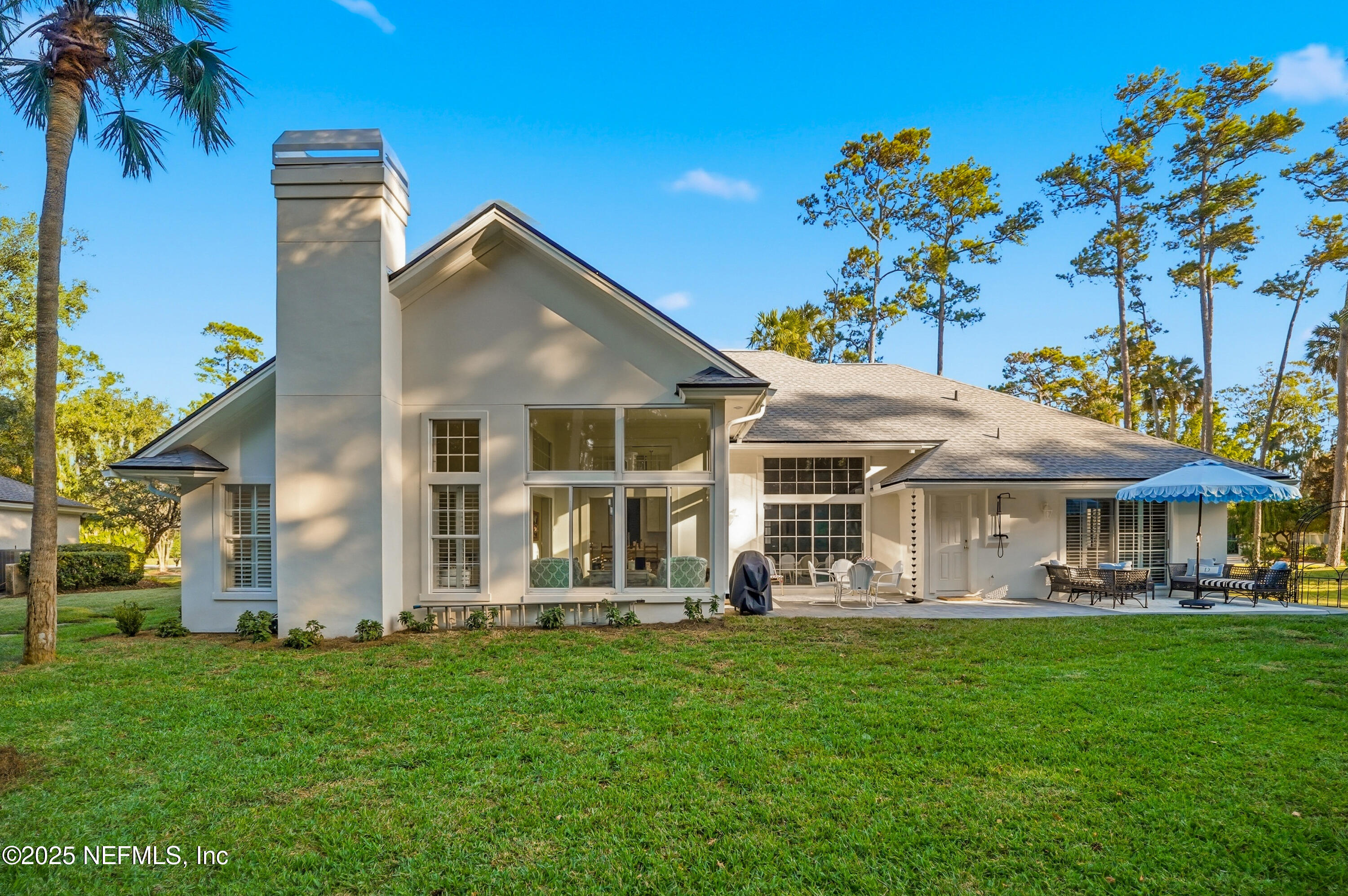 1202 Salt Creek Pointe Way Ponte Vedra Beach, FL 32082 - Photo 39 of 77 a front view of a house with a yard table and chairs