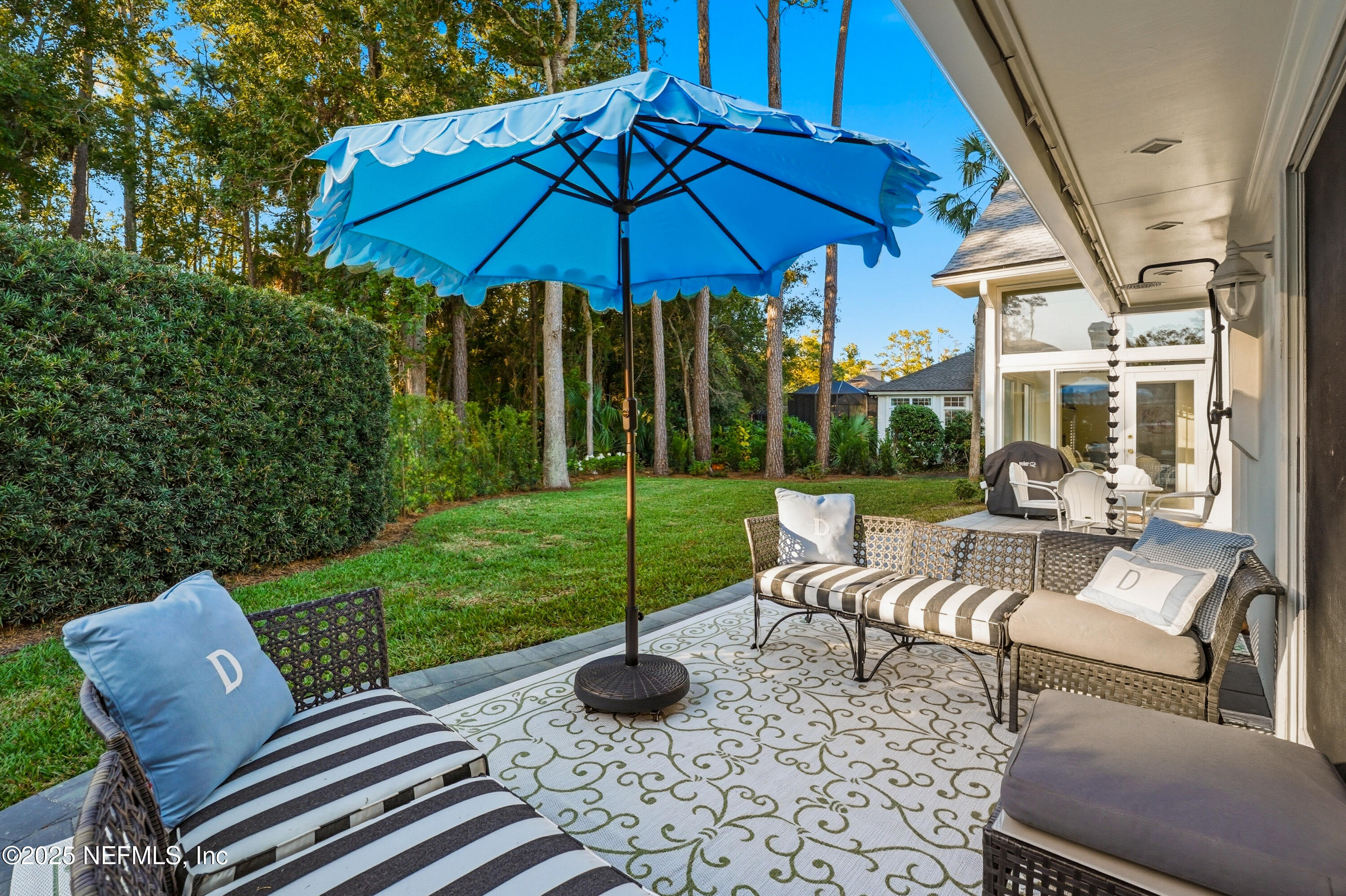 1202 Salt Creek Pointe Way Ponte Vedra Beach, FL 32082 - Photo 45 of 77 a view of a patio with couches chairs and a umbrella
