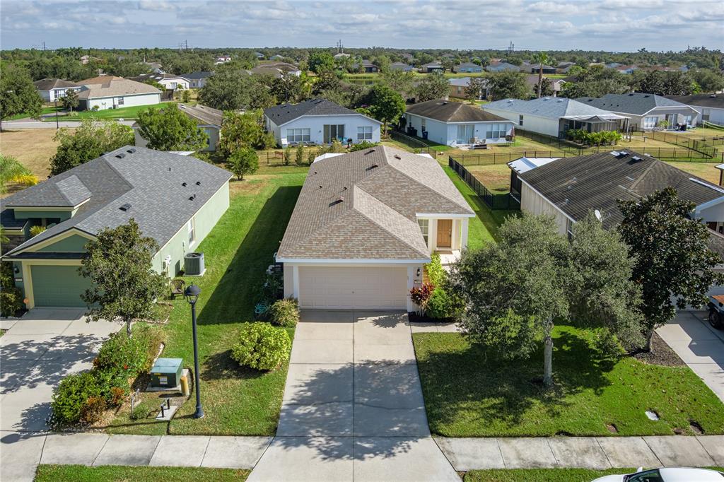 9822 50th St Circle East Parrish, FL 34219 - Photo 2 of 46 an aerial view of multiple houses with a yard