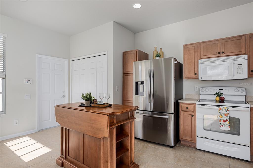 9822 50th St Circle East Parrish, FL 34219 - Photo 6 of 46 a kitchen with stainless steel appliances a refrigerator stove and sink