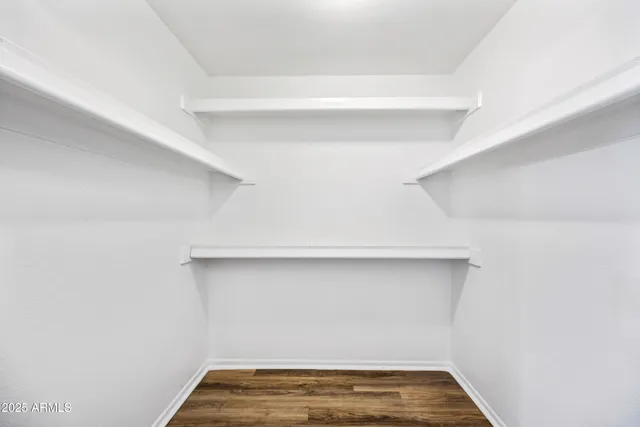 a view of room with stairs and wooden floor