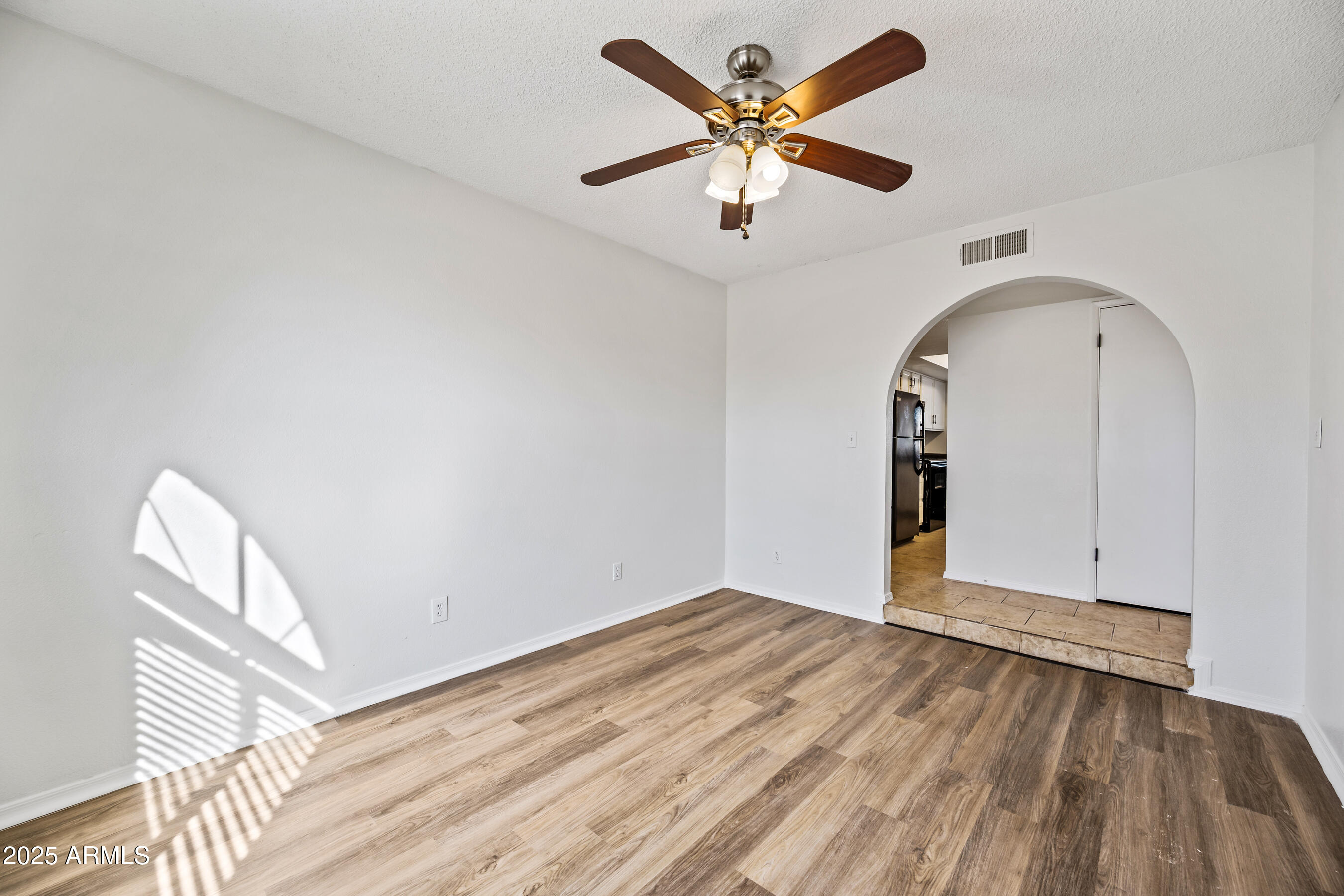 2211 North Bullmoose Drive Chandler, AZ 85224 - Photo 15 of 23 an empty room with wooden floor and windows