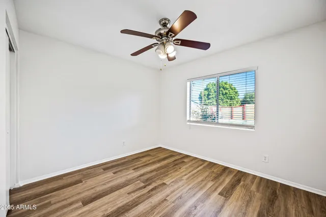 a view of a room with a ceiling fan