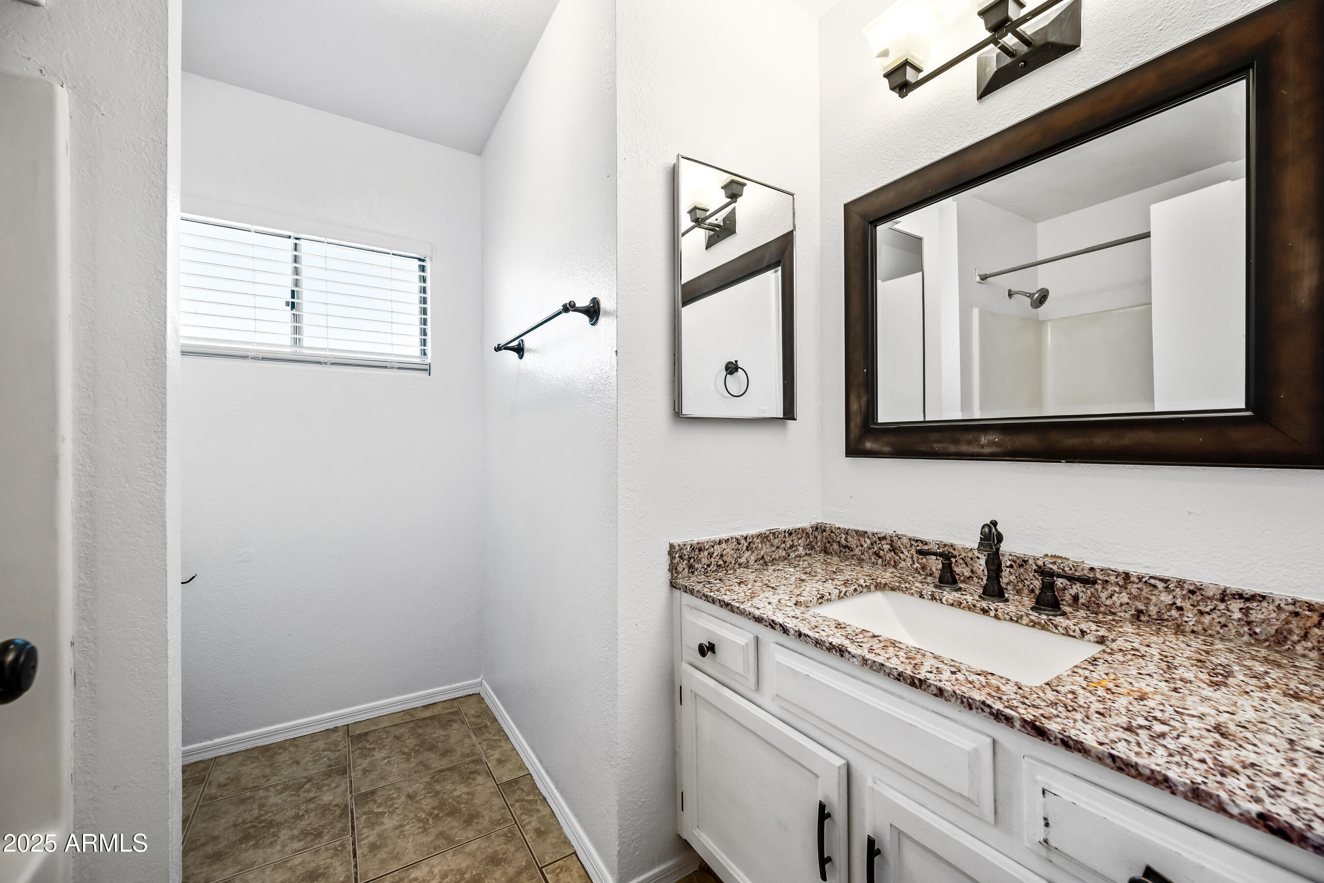 2211 North Bullmoose Drive Chandler, AZ 85224 - Photo 18 of 23 a bathroom with a sink and a mirror