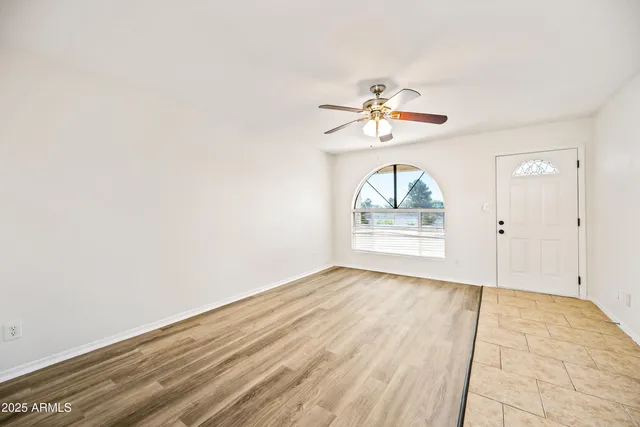 wooden floor in an empty room with a window