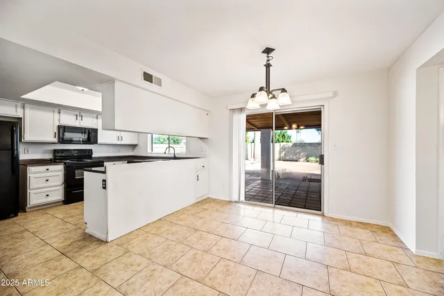 a kitchen with granite countertop a stove cabinets and a counter top space