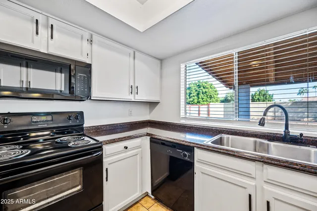 a kitchen with stainless steel appliances a stove sink and cabinets
