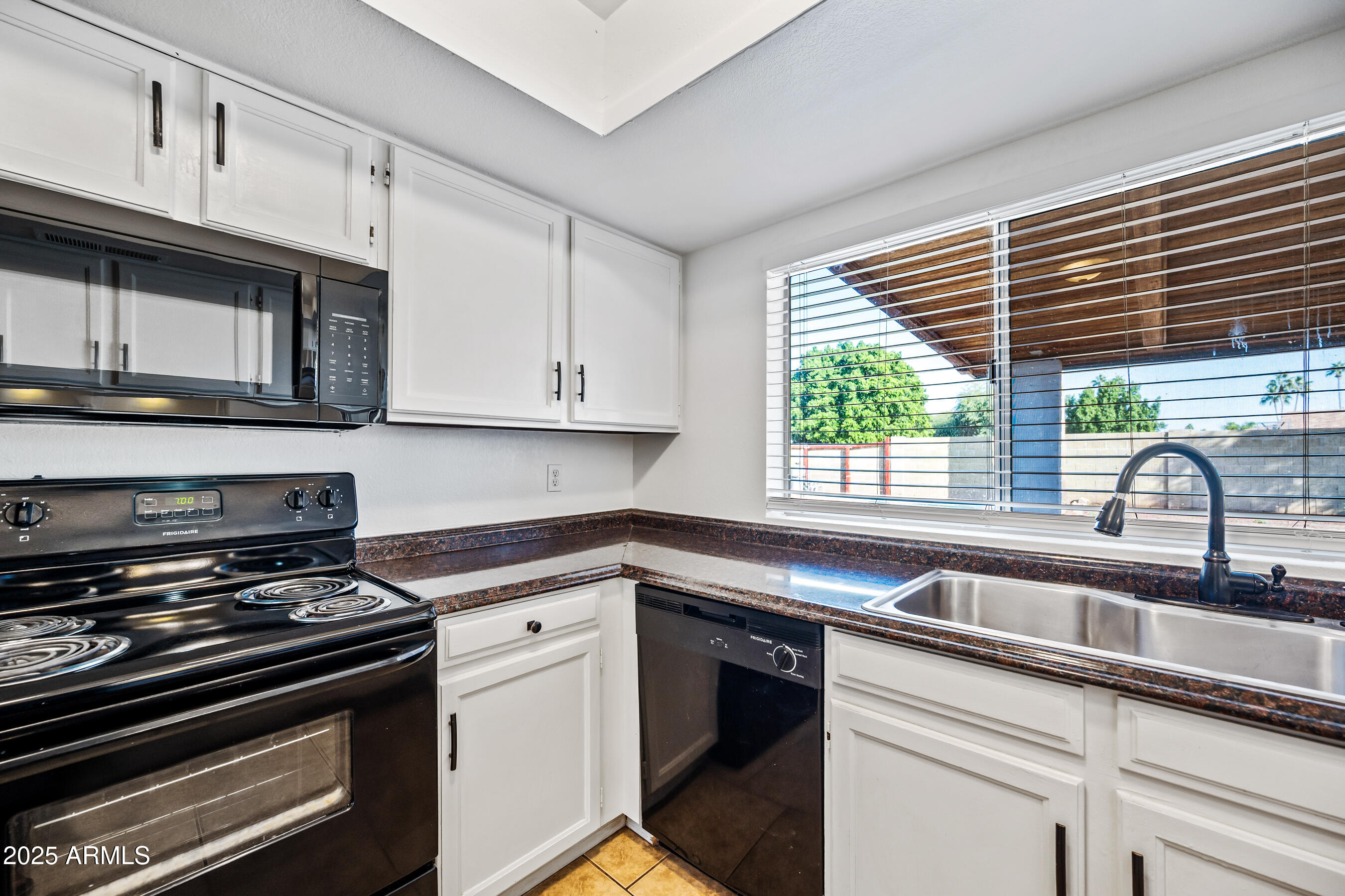 2211 North Bullmoose Drive Chandler, AZ 85224 - Photo 6 of 23 a kitchen with stainless steel appliances a stove sink and cabinets