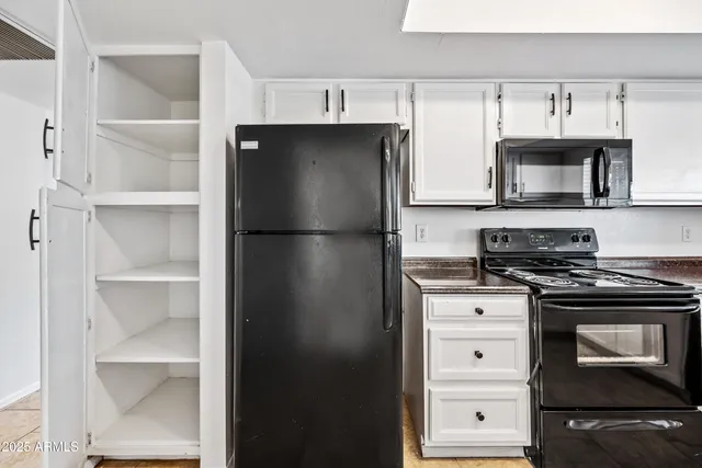 a kitchen with cabinets and stainless steel appliances