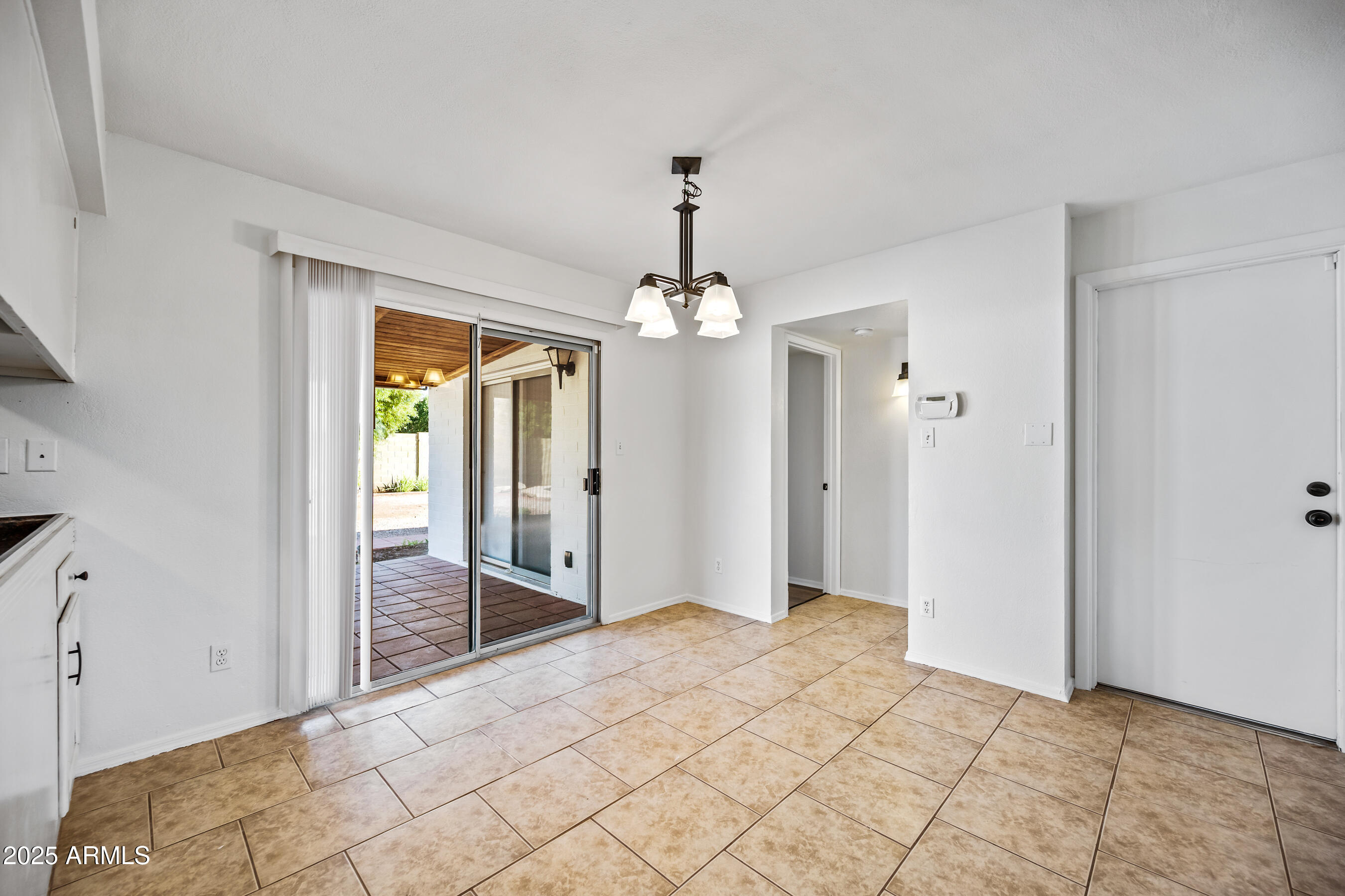 2211 North Bullmoose Drive Chandler, AZ 85224 - Photo 8 of 23 a spacious bedroom with a chandelier and glass door