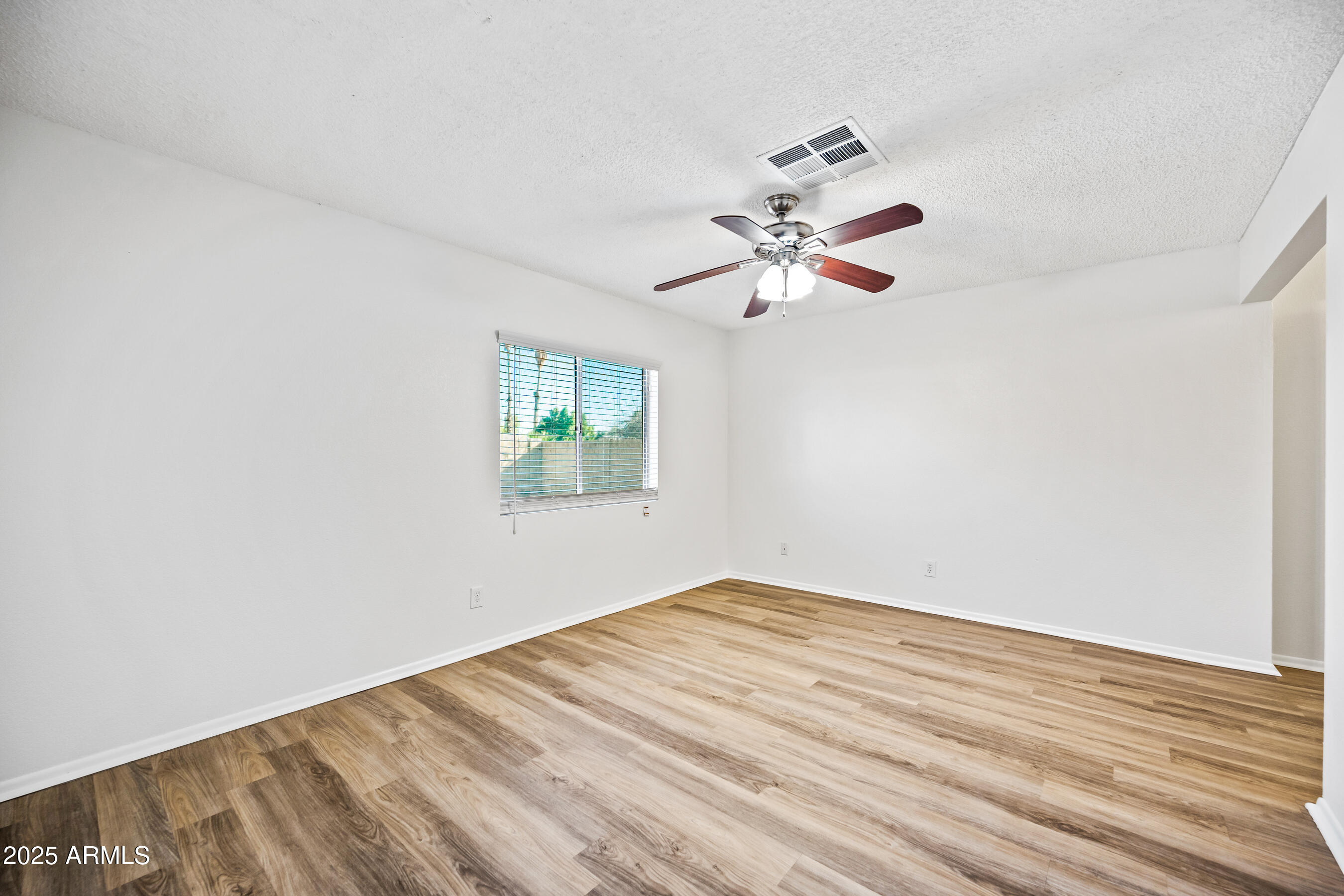 2211 North Bullmoose Drive Chandler, AZ 85224 - Photo 9 of 23 an empty room with a fan and a window