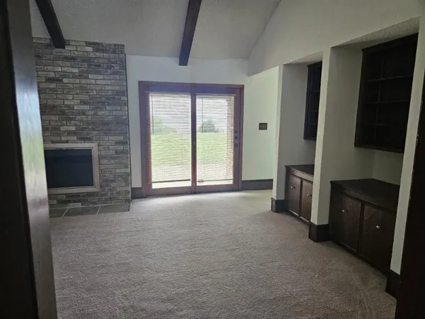 a view of an empty room with a fireplace