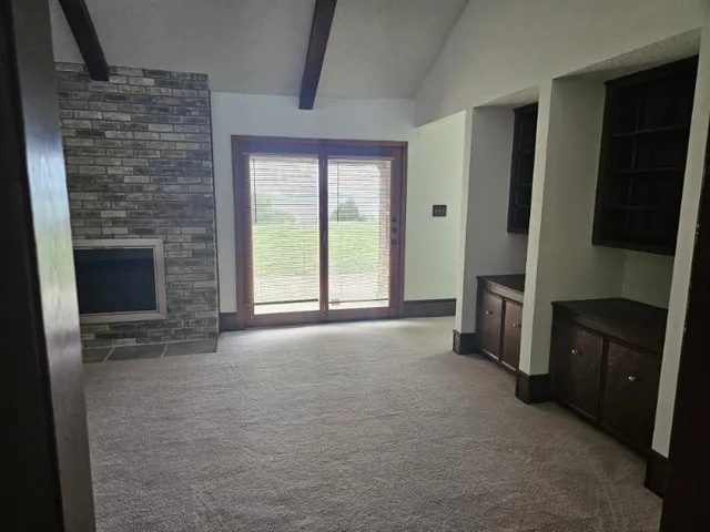 a view of an empty room with a fireplace