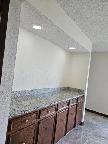 a large kitchen with cabinets and stainless steel appliances