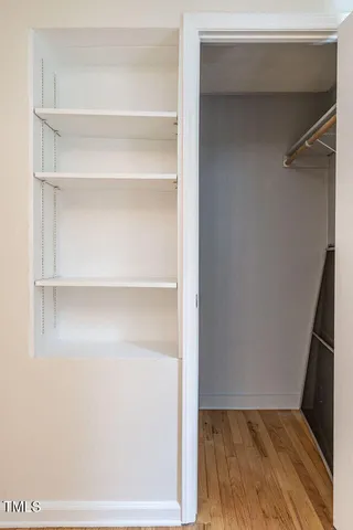a view of walk in closet with empty racks