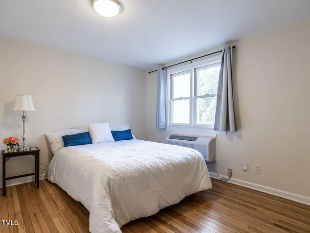 a bedroom with a bed and window