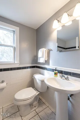 a bathroom with a sink a mirror and a toilet