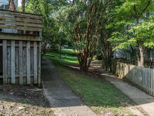 a view of a house with backyard and trees
