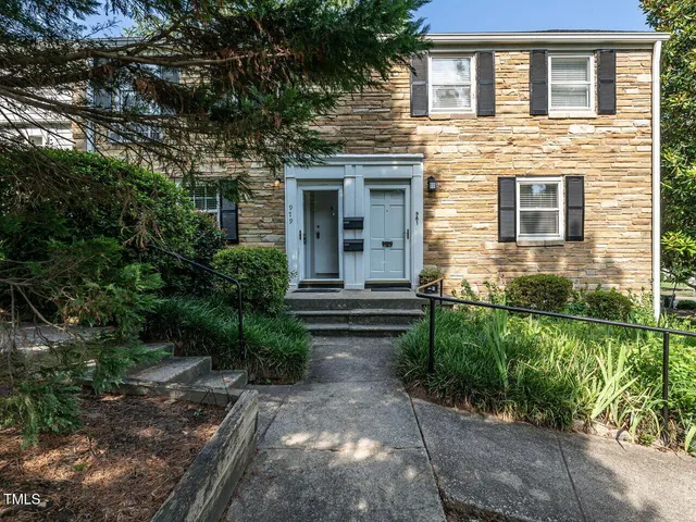 a front view of a house with yard and green space