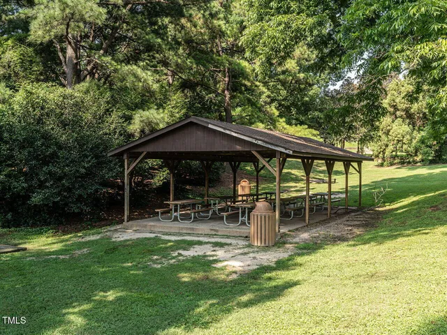 a backyard of a house with yard and outdoor seating