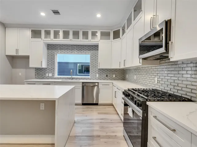 a bathroom with a sink vanity and mirror