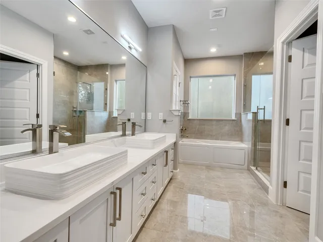 a white bath tub sitting next to a shower
