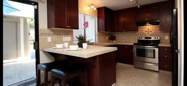 a kitchen with a sink cabinets and appliances