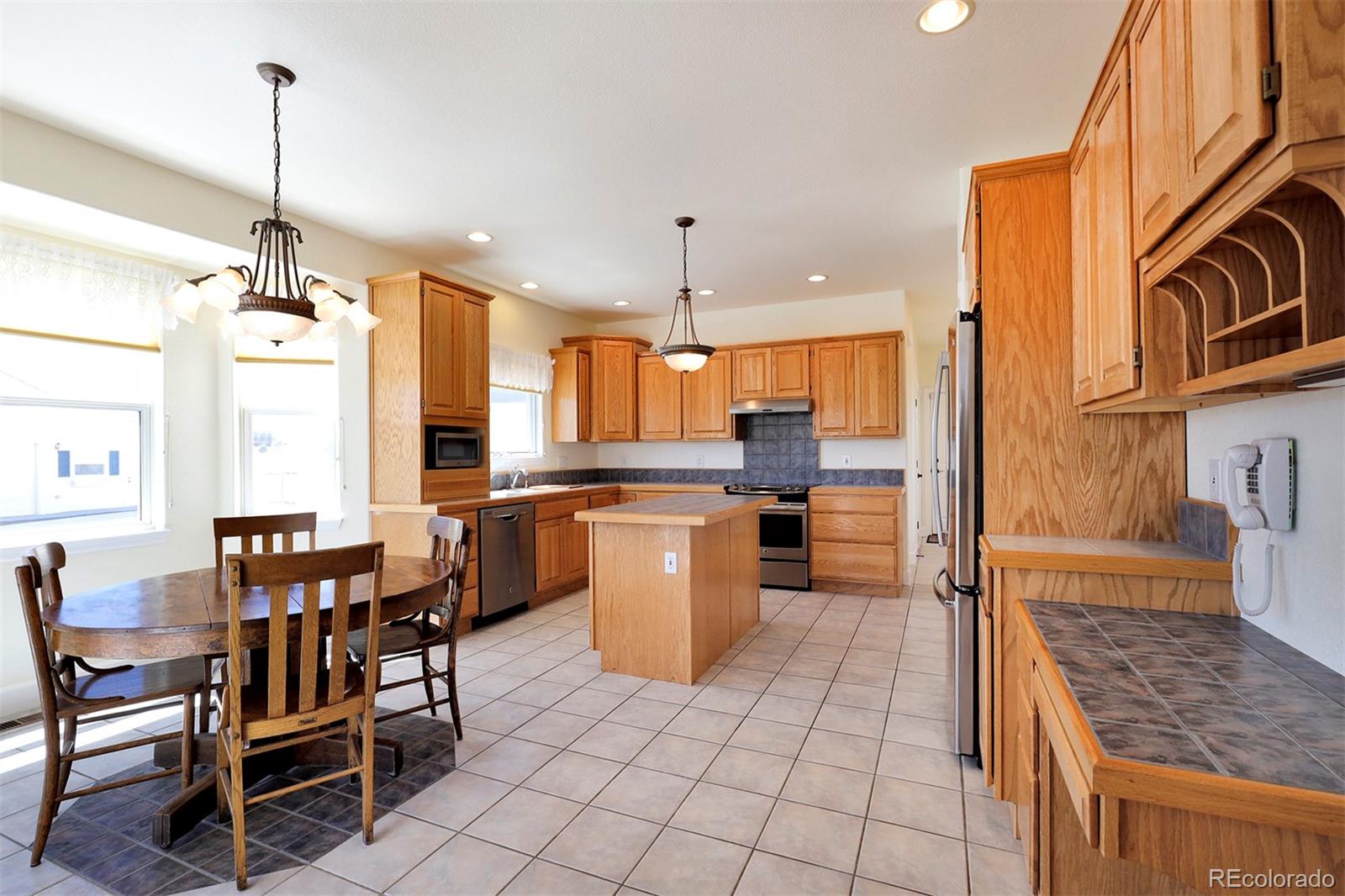 4627 Bayou Hills Road Parker, CO 80134 - Photo 11 of 40 a large kitchen with a table and chairs