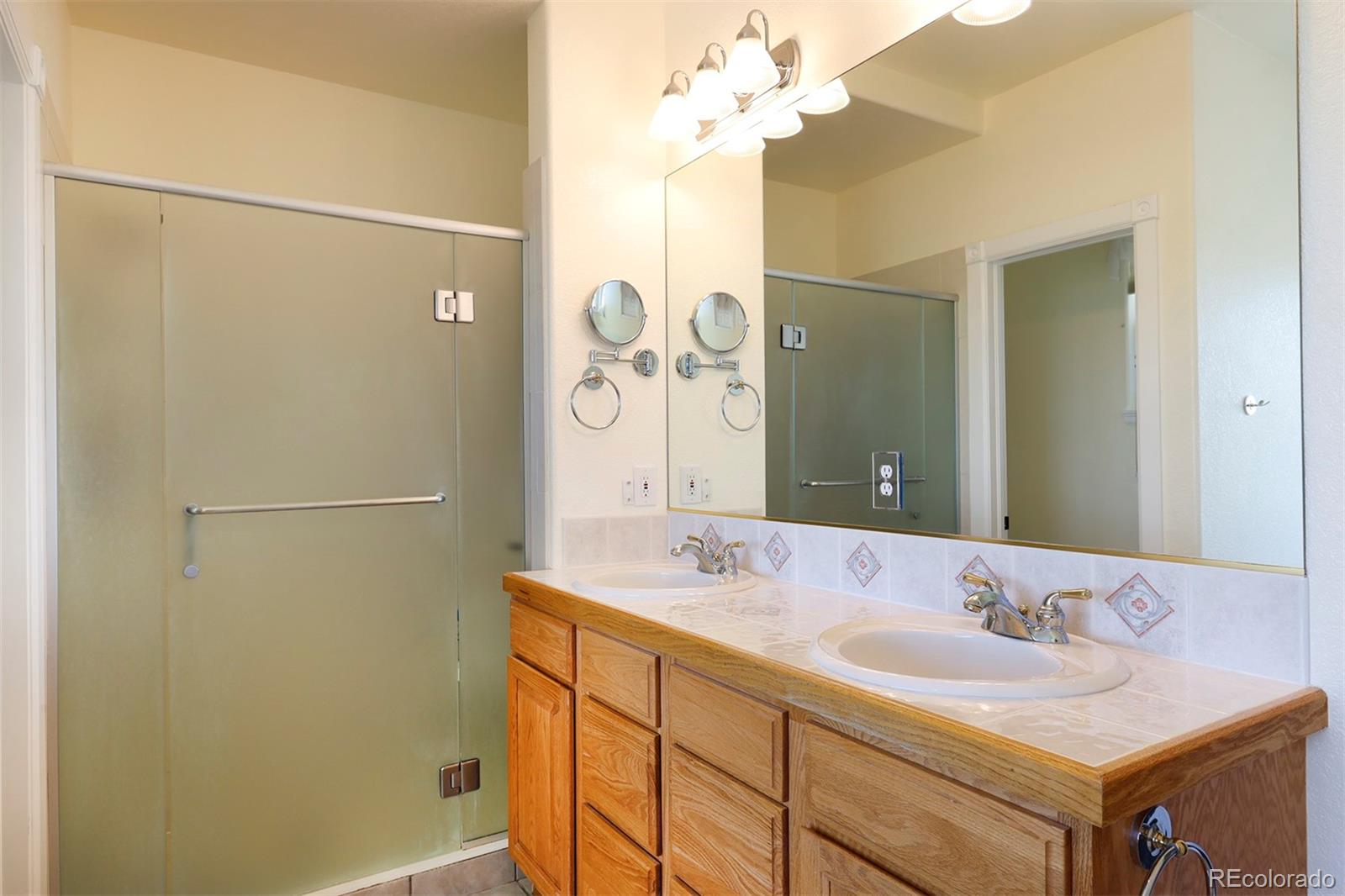 4627 Bayou Hills Road Parker, CO 80134 - Photo 17 of 40 a bathroom with a sink and a mirror