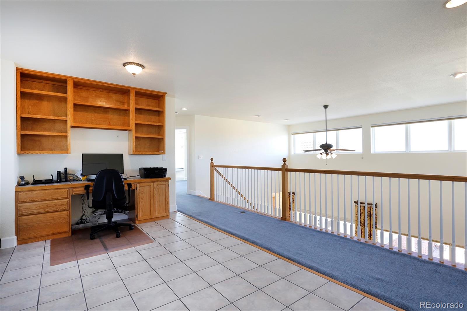 4627 Bayou Hills Road Parker, CO 80134 - Photo 19 of 40 a view of a workspace with furniture and staircase