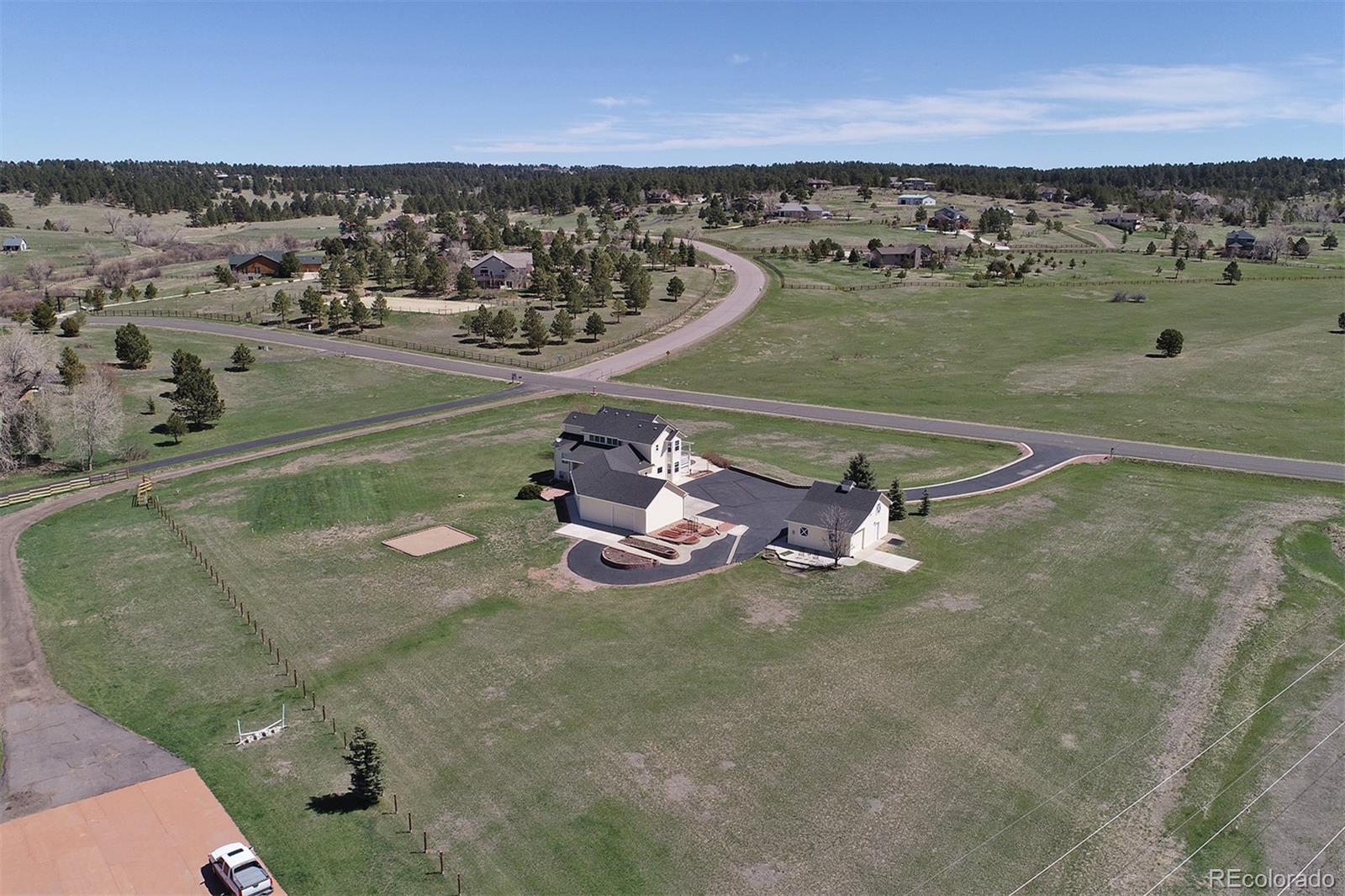 4627 Bayou Hills Road Parker, CO 80134 - Photo 37 of 40 an aerial view of a house with a lake view
