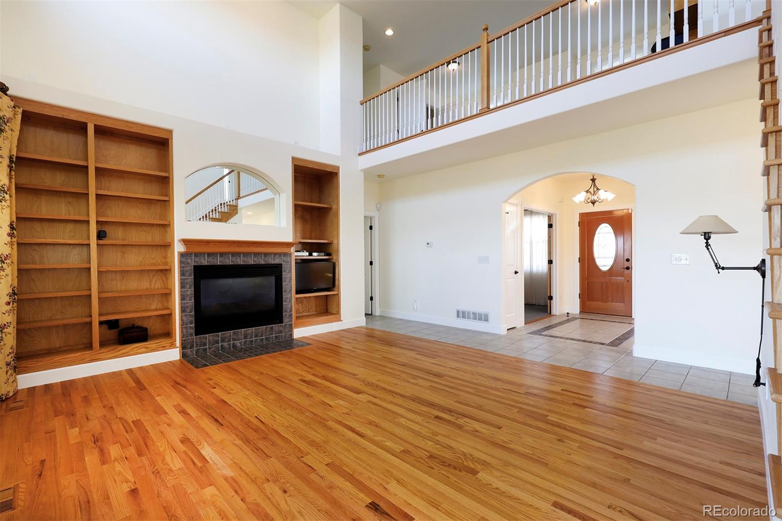 4627 Bayou Hills Road Parker, CO 80134 - Photo 4 of 40 a view of empty room with a fireplace and wooden floor