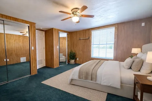 a bedroom with a bed and a chandelier