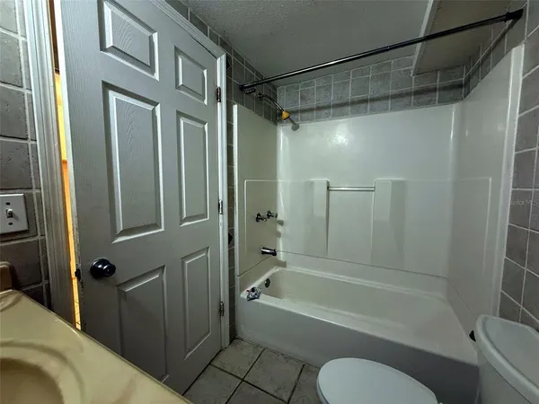 a front view of a house with a garden and tree