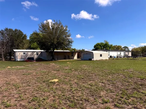 a view of a backyard with a patio