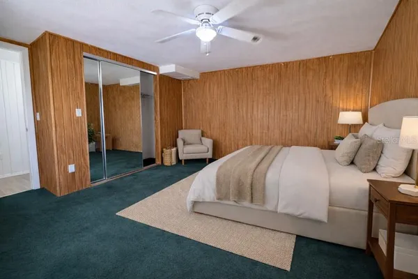 a bedroom with a bed and a chandelier