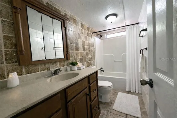 a view of a hallway with wooden floor and a window