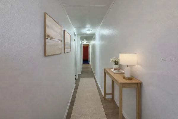 a view of a room with wooden floor