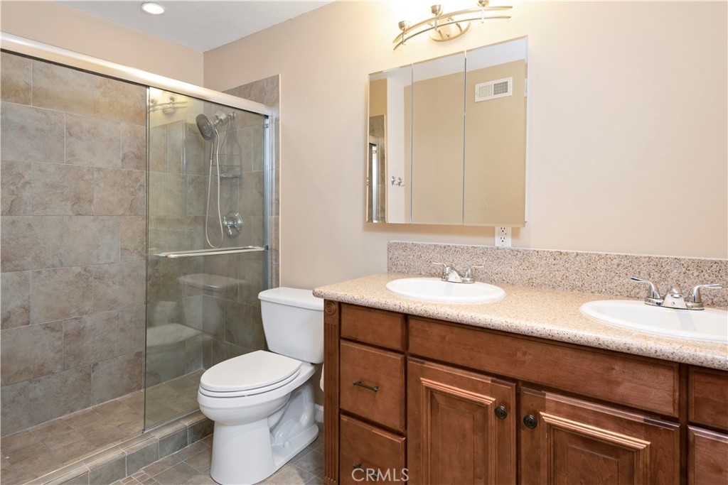 12 Rapallo Irvine, CA 92614 - Photo 17 of 21 a bathroom with a sink a toilet and shower