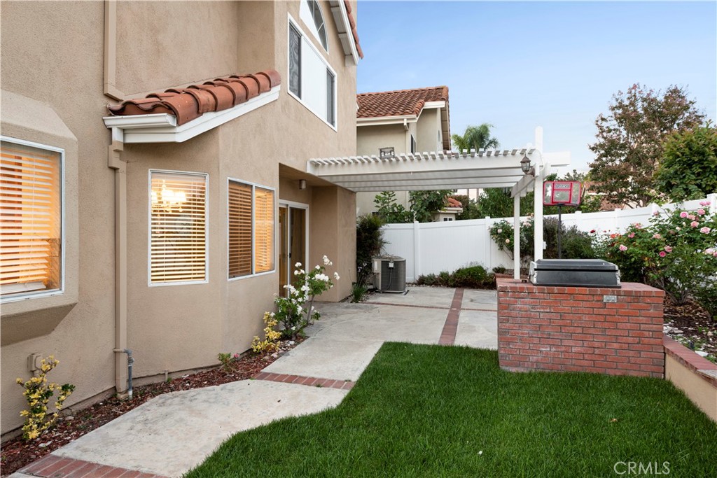 12 Rapallo Irvine, CA 92614 - Photo 19 of 21 a front view of a house with a garden and plants