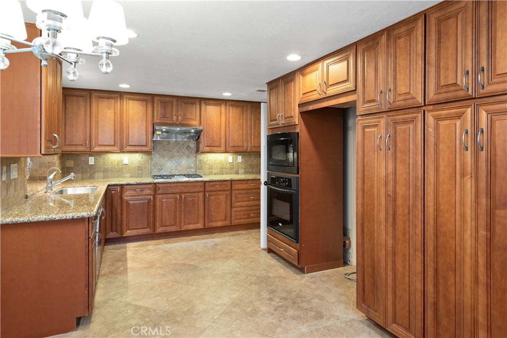 12 Rapallo Irvine, CA 92614 - Photo 8 of 21 a kitchen with granite countertop a sink cabinets stainless steel appliances and a window