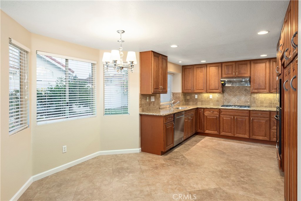 12 Rapallo Irvine, CA 92614 - Photo 9 of 21 a kitchen with a sink window and cabinets