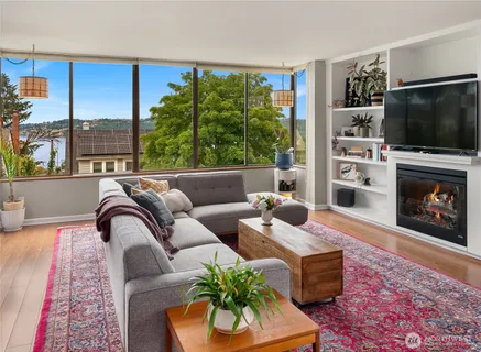 a living room with furniture a flat screen tv and a fireplace