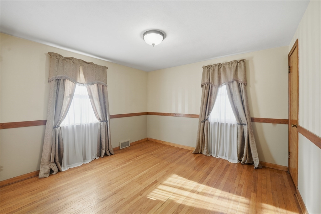 80 Jean Drive Springfield, MA 01104 - Photo 18 of 42 a view of an empty room with wooden floor and a window